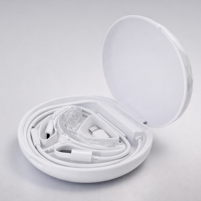 White electronic cable in an open white case on a light gray background