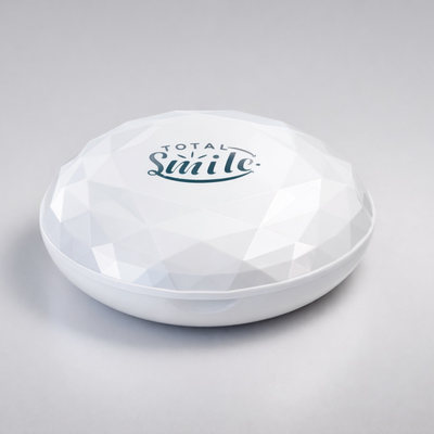 White diamond-shaped object with 'Total Smile' logo on a gray background